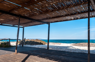 View of the sea from a reed gazebo