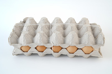 Fifteen yellow eggs ready to cook in the box