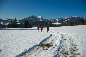 3 hikers in snowy mountain landscape