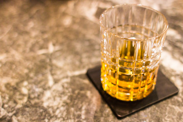 Background with a glass of whiskey or rum