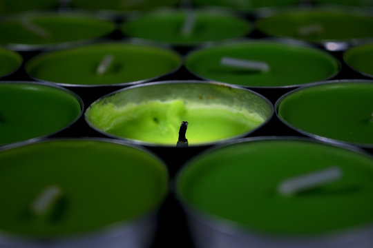 Green candle, One dark candle and one light burned candle