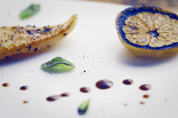 Steak of sea fish halibut with lemon on the grill. Rustic style. Toning. Selected focus.