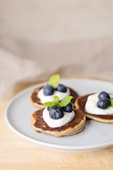 Healthy pancakes with white yogurt, blueberries and agava syrup