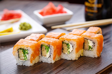 Beautifully decorated sushi on a wooden board.