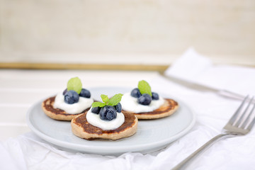 Healthy pancakes with white yogurt, blueberries and agava syrup