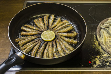 Ancovies cooking in a pan in the kitchen