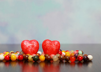 The background for the label. Two red hearts and beads.