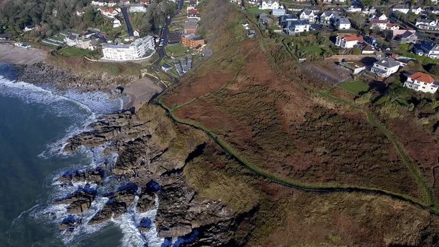 SWANSEA, UK - JANUARY 26, 2018: Ariel view of a small section of the Wales Coastal Path as it winds its way past Rotherslade Bay and Langland Bay on the Gower peninsula in Swansea, UK.