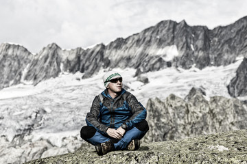 Naklejka na ściany i meble Alpinist enjoys the peace and solitude in the Swiss Alps