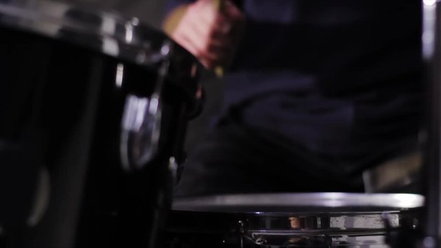 drummer play in studio on black background 