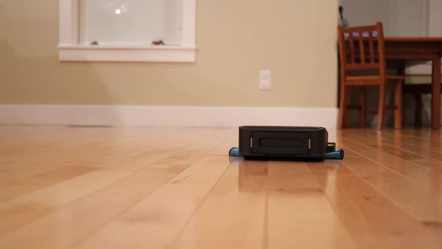 A robot mop cleaning the floor inside home