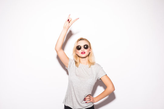 Stylish fashion blonde bad girl in a t-shirt and rock sunglasses dangerous rocky emotional woman on white background