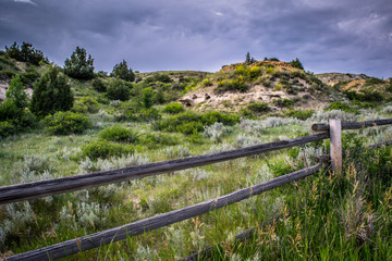 FENCING MONTANA LAND AND STORMY SKY