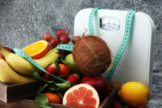 Healthy living or Diet concept. Fruits with measuring tape and a weight scale