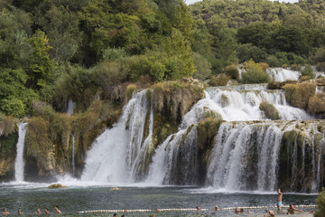 People bathing in Krka national park, through nature