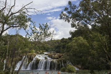 SIBENIK, CROATIA: Day view of Krka waterfalls in the natual park, with people bathing in the lake