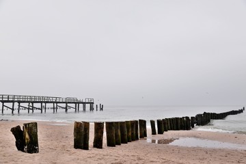 old wooden breakwater on the baltic beach after the season