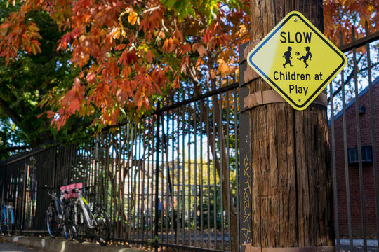 Slow children at play sign with fall leaves in backdrop