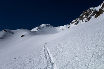 Fototapeta na wymiar A ski touring track leading up to alpine mountain pass