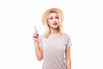 Young woman thinking in white hat and finger pointing up for breakthrough thinking ideas concepts...