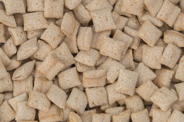 Stuffed breakfast cereal pillows as background.