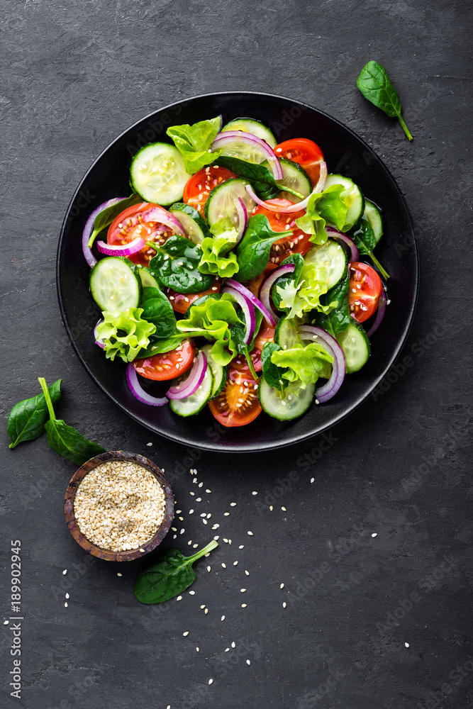 Poster healthy vegetable salad of fresh tomato, cucumber, onion, spinach, lettuce and sesame on plate. diet