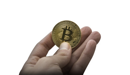 An isolated image of a hand holding a physical Bitcoin on a white background. Bitcoin is a crypto currency and a worldwide payment system.