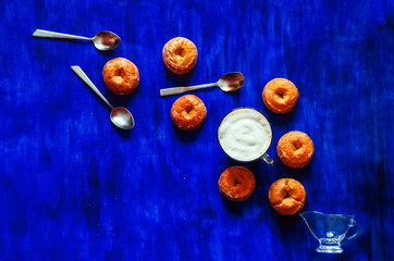 coffee and biscuits. teaspoons. view from above. blue background. food and drink
