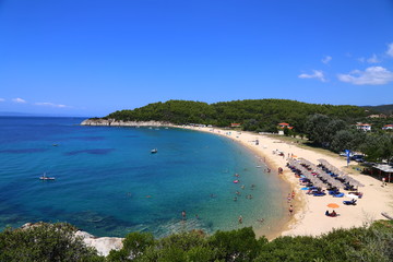 Fototapeta premium Panoramic view of the lagoon with vacationers. Blue water and umbrellas from the sun