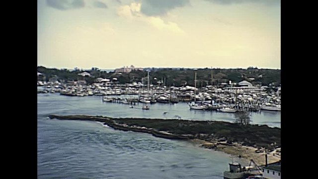 Bahamas Nassau harbour in New Providence island coastline with fishing boats and yacht in 70's. The historical Bahamas in 1978.