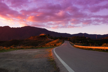 Road. Road in the mountains. Clouds, sunset landscape. Andalusia, Spain.