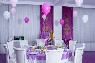  Pink tablecloth . White chairs . White wedding table. A table decorated with balloons.