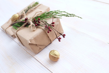 Fototapeta na wymiar Christmas gift boxes and fir tree branch on wooden table. Сhristmas background