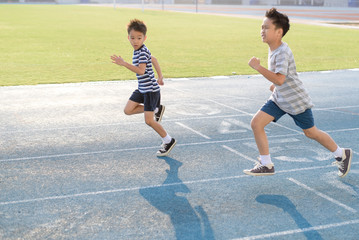 Boy running on the blue track