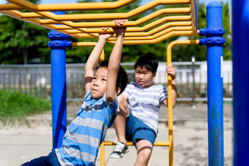 Fototapeta na wymiar Young asian boy hang out door playground