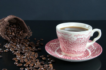 Coffee cup and coffee beans on table