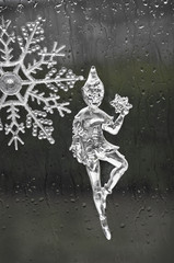 Elf fairy holding a snowflake made out of ice/Elf Christmas ornament figurine in ice holding a snowflake