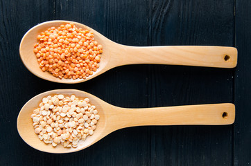 Spoons filled with uncooked lentil for soup