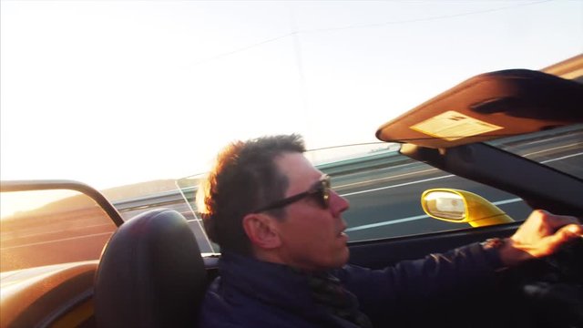 Middle aged man is driving his luxurious cabriolet moving along the road in morning Vladivostok, Russia