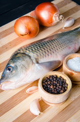 Uncooked fish on cutting board in meal preparation concept