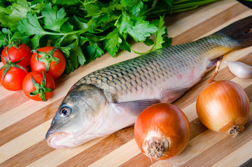 Uncooked fish on cutting board in meal preparation concept