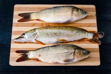Uncooked fish on cutting board in meal preparation concept