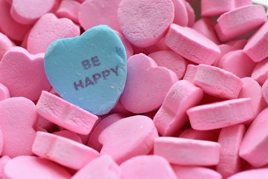 Blue "Be Happy" in pink conversation hearts