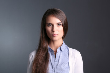 Portrait of a businesswoman , against dark background. Woman smiling. Portrait of a woman