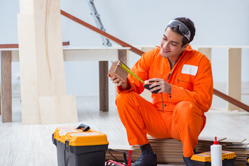 Contractor working on laminate wooden floor 