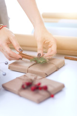 Hands of woman decorating christmas gift box. Hands of woman