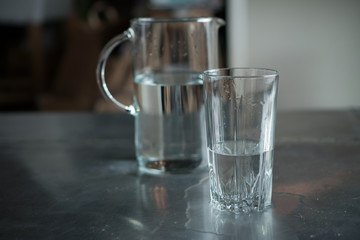 pouring water from a pitcher into a glass