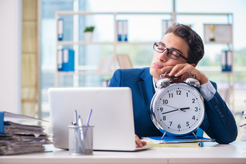 Businessman with giant clock failing to meet deadlines and missi