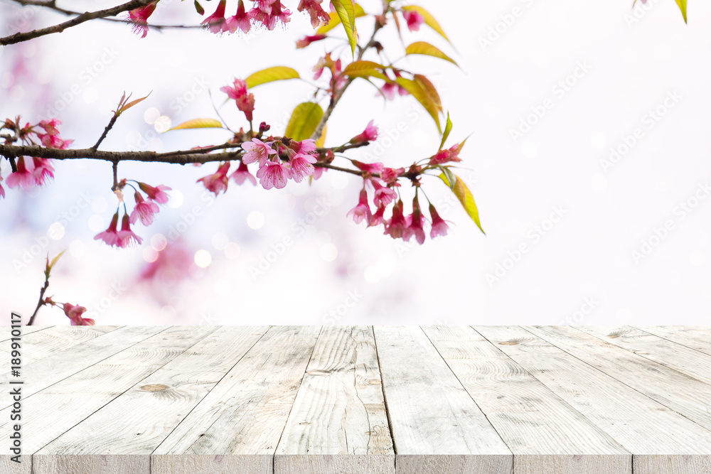 Wall mural top of wood table empty ready for your product and food display or montage with pink cherry blossom 