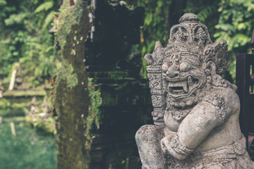 Fototapeta na wymiar Hindu stone statue in the balinese temple. Tropical island of Bali, Indonesia.